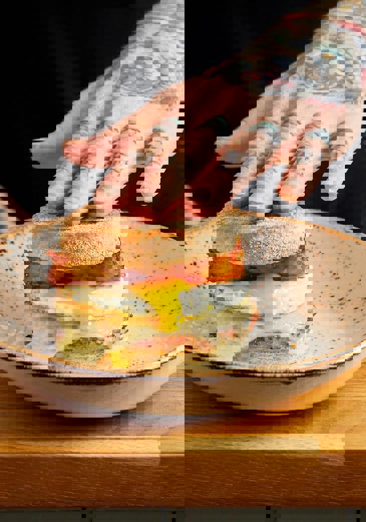 Our signature Sausage breakfast muffin. Sausage patty, melted cheese, runny fried egg and homemade hash browns