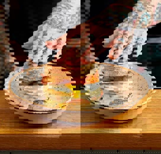 Our signature Sausage breakfast muffin. Sausage patty, melted cheese, runny fried egg and homemade hash browns