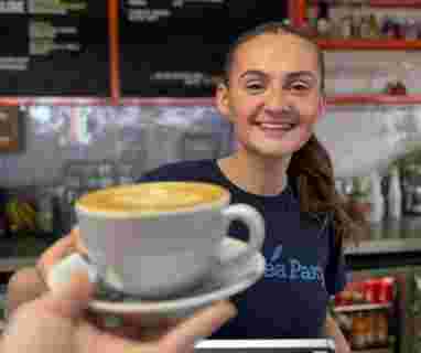 Team Handing Over Latte